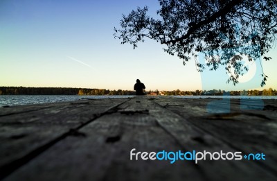 Lone Fisherman Sunset Pier Stock Photo