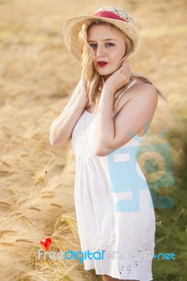 Lonely Beautiful Young Blonde Girl In White Dress With Straw Hat… Stock Photo