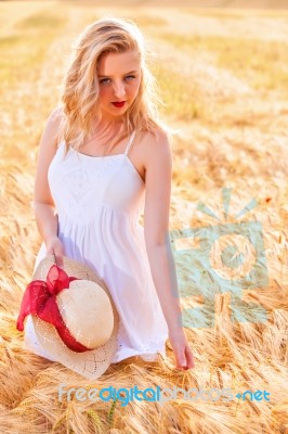 Lonely Beautiful Young Blonde Girl In White Dress With Straw Hat… Stock Photo