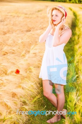 Lonely Beautiful Young Blonde Girl In White Dress With Straw Hat… Stock Photo