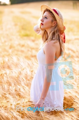 Lonely Beautiful Young Blonde Girl In White Dress With Straw Hat… Stock Photo