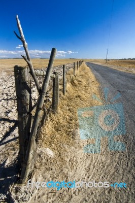 Long Asphalt Road On Vast Dry Land Stock Photo