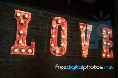 Love Bulb Sign Decorated On Brick Wall Stock Photo