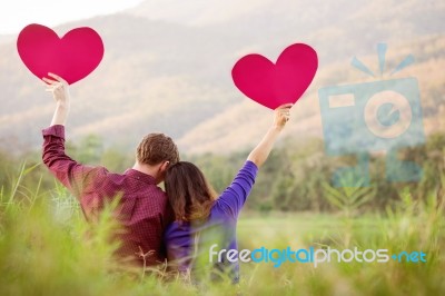 Loving Couple. Beautiful Young Love Couple Holding Paper Hearts Stock Photo