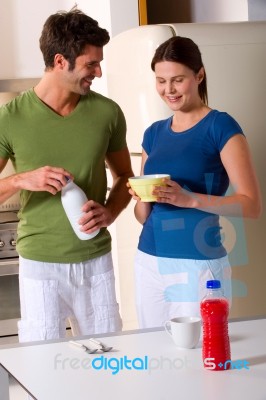 Loving Couple In Kitchen Stock Photo