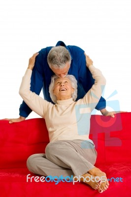 Loving Couple Sitting In Sofa Stock Photo