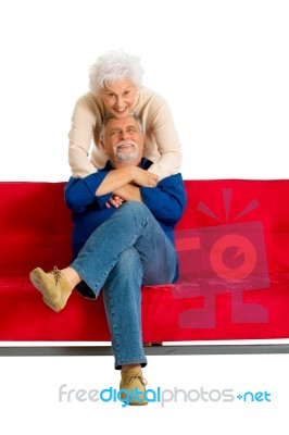 Loving Couple Sitting In Sofa Stock Photo