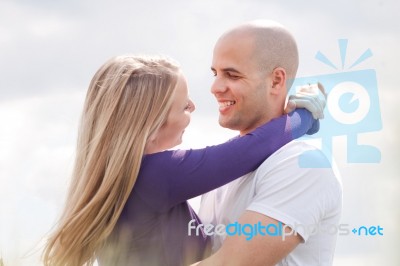 Loving Couple Standing Under The Blue Sky Stock Photo