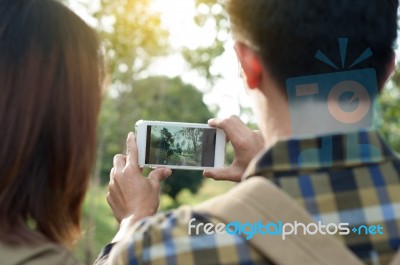 Loving Traveler Couple Taking Pictures Using Mobile Phone Photog… Stock Photo