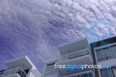 Low Rise Modern Architecture In Blue Cloud Sky Stock Photo