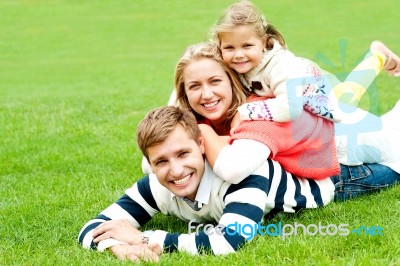 Lying Family In Outdoors Stock Photo