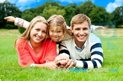 Lying Family In Outdoors Stock Photo