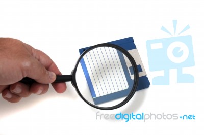 Magnifying Glass On Floppy Disk Stock Photo