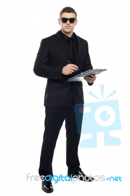 Male Bouncer Holding Clipboard Stock Photo