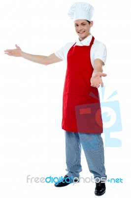 Male Chef Giving Welcome Gesture Stock Photo