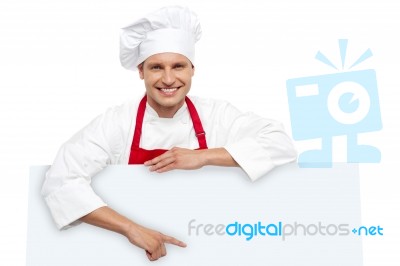 Male Chef Posing Behind Blank Board Stock Photo