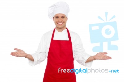 Male Chef Showing Welcome Gesture Stock Photo
