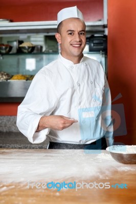 Male Chef Working In Kitchen Stock Photo