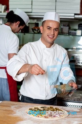 Male Chefs Actively Working In Kitchen Stock Photo