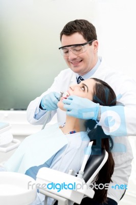 Male Dentist Attending His Patient Stock Photo