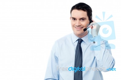 Male Employee Assisting Customer On Call Stock Photo