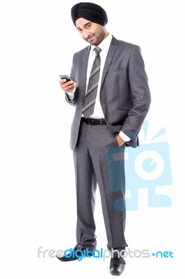 Male Executive Sending Text Message Stock Photo