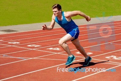 Male Runner On Starting Blocks Stock Photo