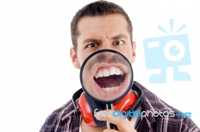 Male Showing Teeth Through Magnifying Glass Stock Photo