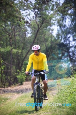Man And Mountain Bike Riding In Jungle Track Use For Bicycle Spo… Stock Photo
