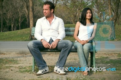 Man And Woman Sitting On A Chair Stock Photo