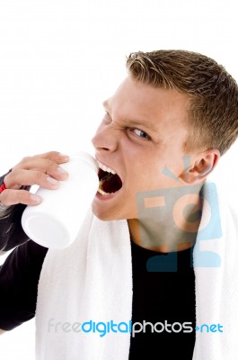 Man Biting Bottle Stock Photo