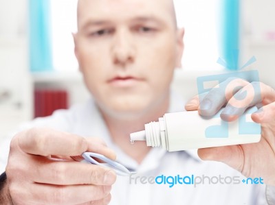 Man Clean Contact Lens At Home Stock Photo