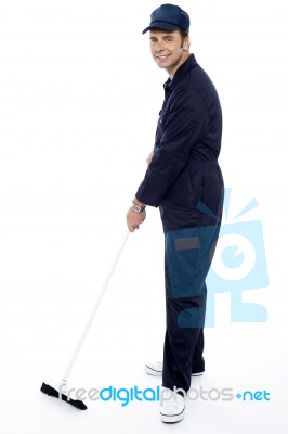 Man Cleaning with broom brush Stock Photo