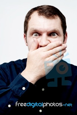 Man Covering His Mouth With His Hand Stock Photo