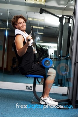 Man Exercising With Help Of A Hydraulic Equipment Stock Photo