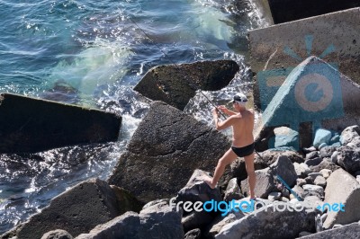 Man Fishing In San Juan Tenerife Stock Photo