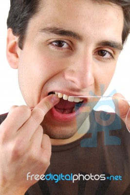 Man Flossing His Teeth Stock Photo