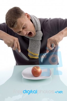 Man Going To Eat Apple With Fork And Knife Stock Photo