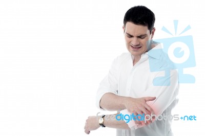 Man Has Pain In The Elbow Stock Photo