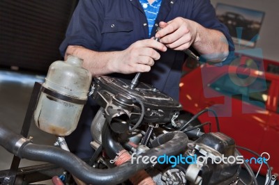 Man Holding A Spanner Over A Car Engine Stock Photo