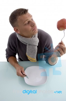 Man Holding Apple With Fork Stock Photo