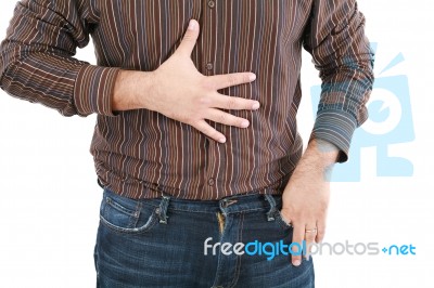 Man Holding His Stomach In Pain Or Indigestion Stock Photo