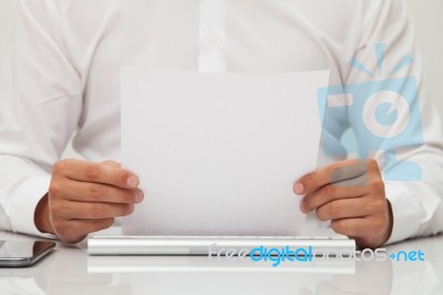 Man Holds Blank Sheet Of Paper In Hands Stock Photo