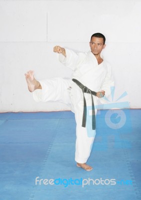 Man In A Kimono Hits With Foot And Hand.  Karate Concept Stock Photo