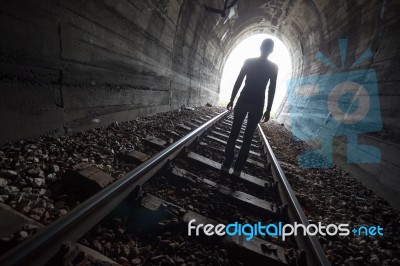Man In A Tunnel Looking Towards The Light Stock Photo