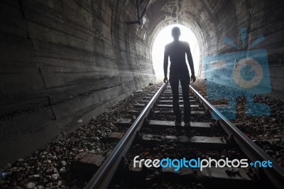 Man In A Tunnel Looking Towards The Light Stock Photo