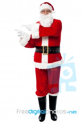 Man In Santa Costume Indicating At Copy Space Area Stock Photo