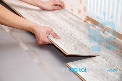 Man Laying Laminate Flooring Stock Photo