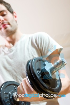 Man Lifting Dumbbell In Gym Stock Photo