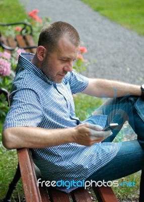 Man Looking At Smartphone Stock Photo